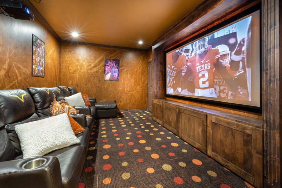 Alternate view of in-apartment media and theater room with comfortable chairs and large-screen TV