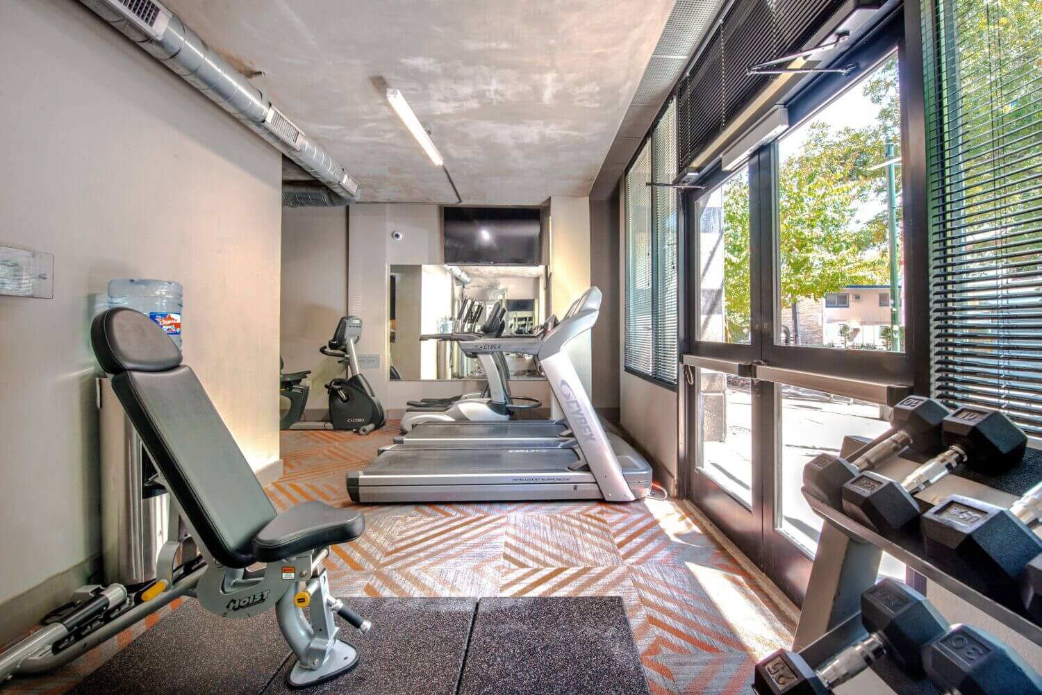 Alternate view of fitness center with treadmills, elliptical, free weights and strength training equipment